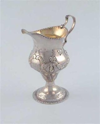 Appraisal: A George III baluster cream jug on a raised circular