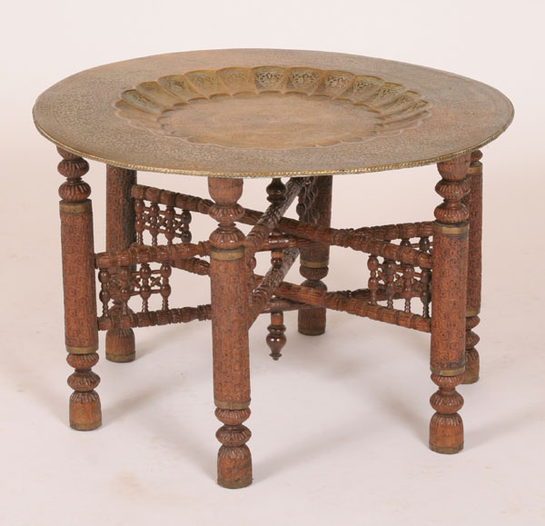 Appraisal: Embossed brass tray table with carved folding legs