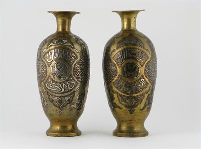 Appraisal: A pair of Cairoware vases decorated in silver with panels