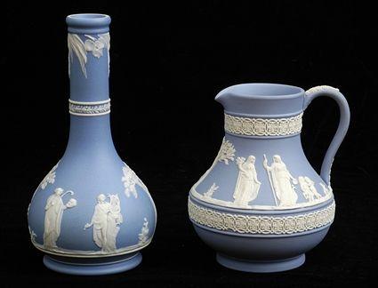 Appraisal: WEDGWOOD BLUE JASPERWARE BOTTLE VASE AND A CREAMER JUG Impressed