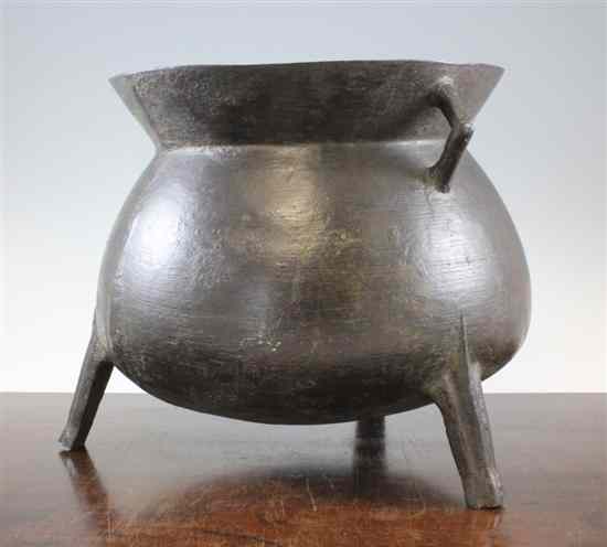 Appraisal: A bronze three legged cauldron th century with two angular