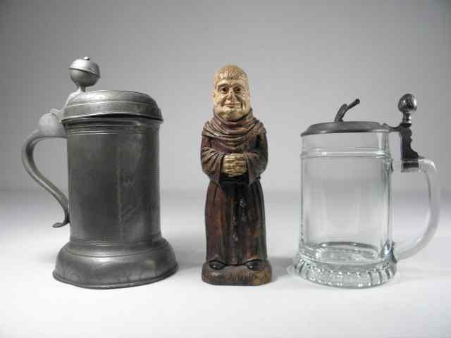 Appraisal: Lot of two German tankards and a carved wood figural