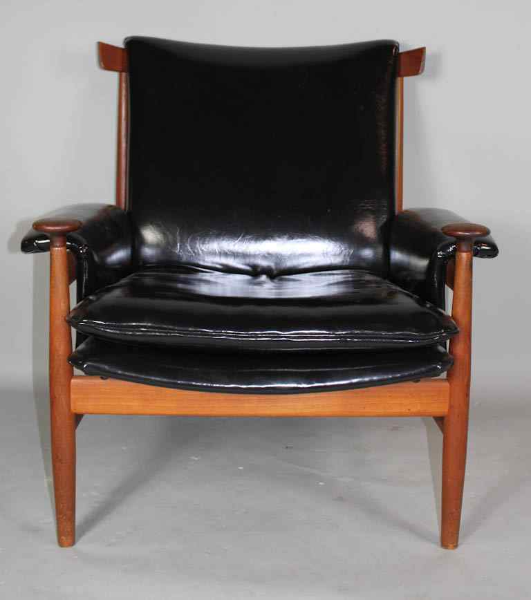 Appraisal: FINN JUHL BWANA ARMCHAIR BLACK LEATHER possibly teakwood the concave