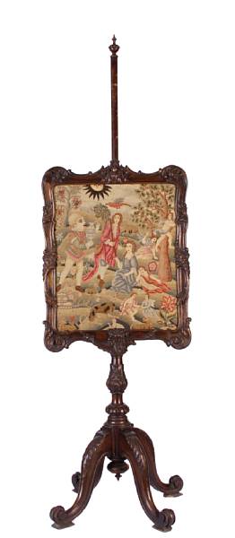 Appraisal: A Victorian carved walnut fire screen with inset needlepoint tapestry