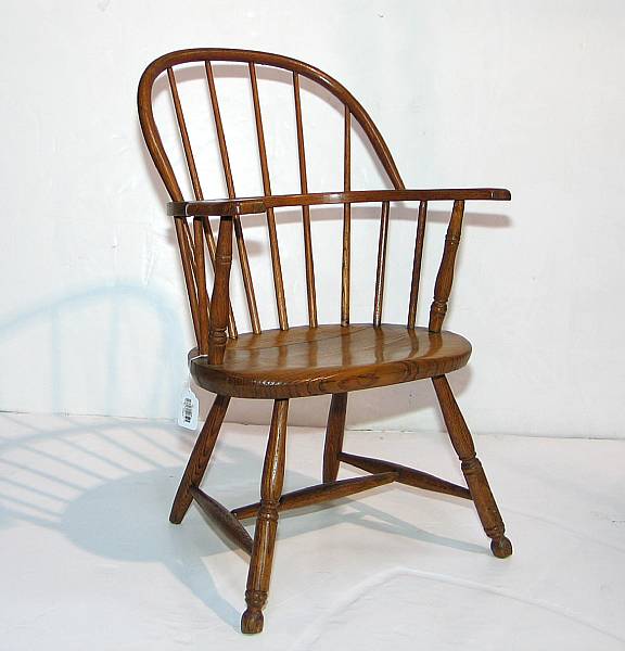 Appraisal: A mixed wood sack back Windsor armchair second half th