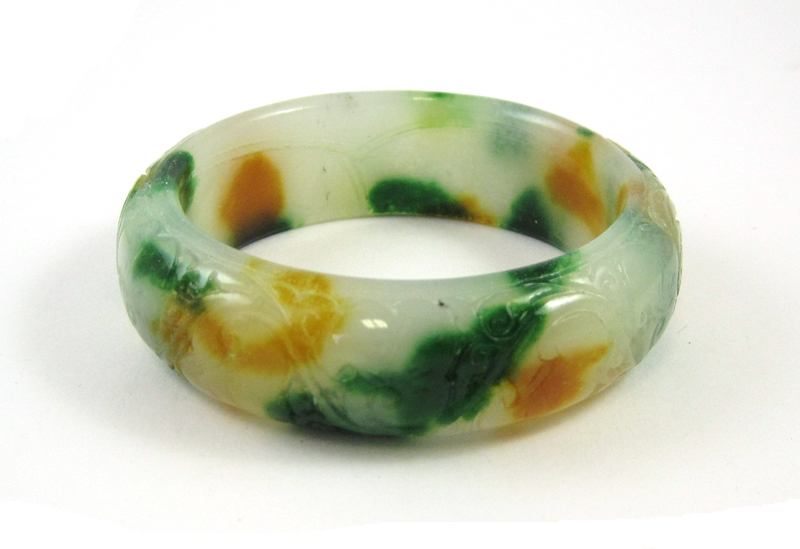 Appraisal: CARVED MULTI-COLOR HARDSTONE BANGLE The light green dark green and