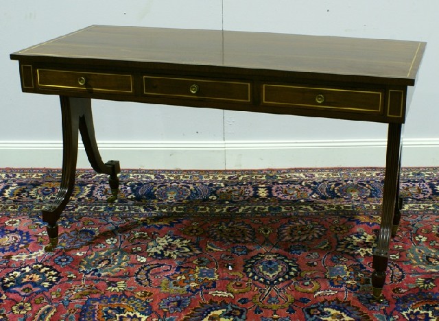 Appraisal: A Regency style mahogany and brass inlaid sofa table with