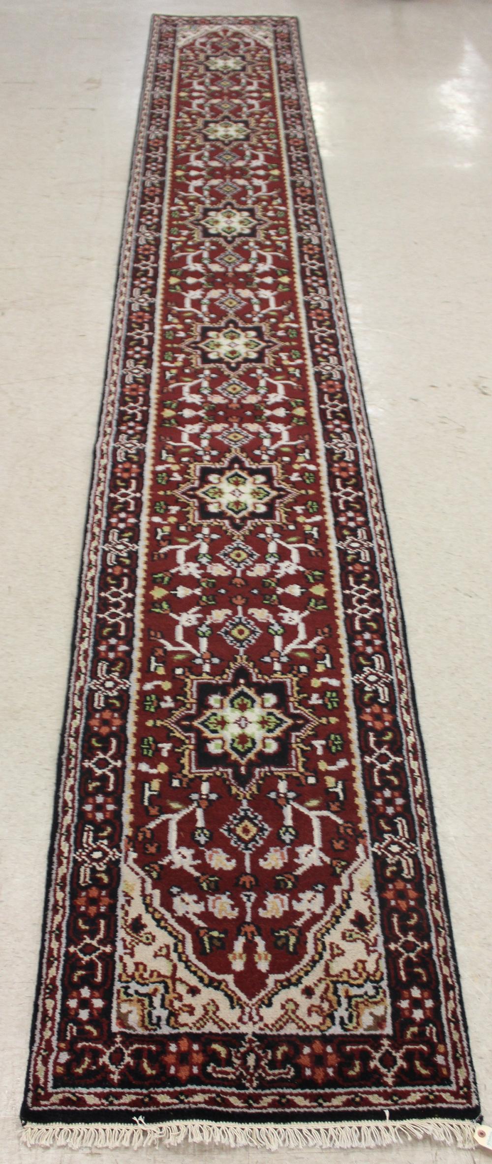 Appraisal: HAND KNOTTED ORIENTAL RUNNER Indo-Persian six geometric medallions and stylized