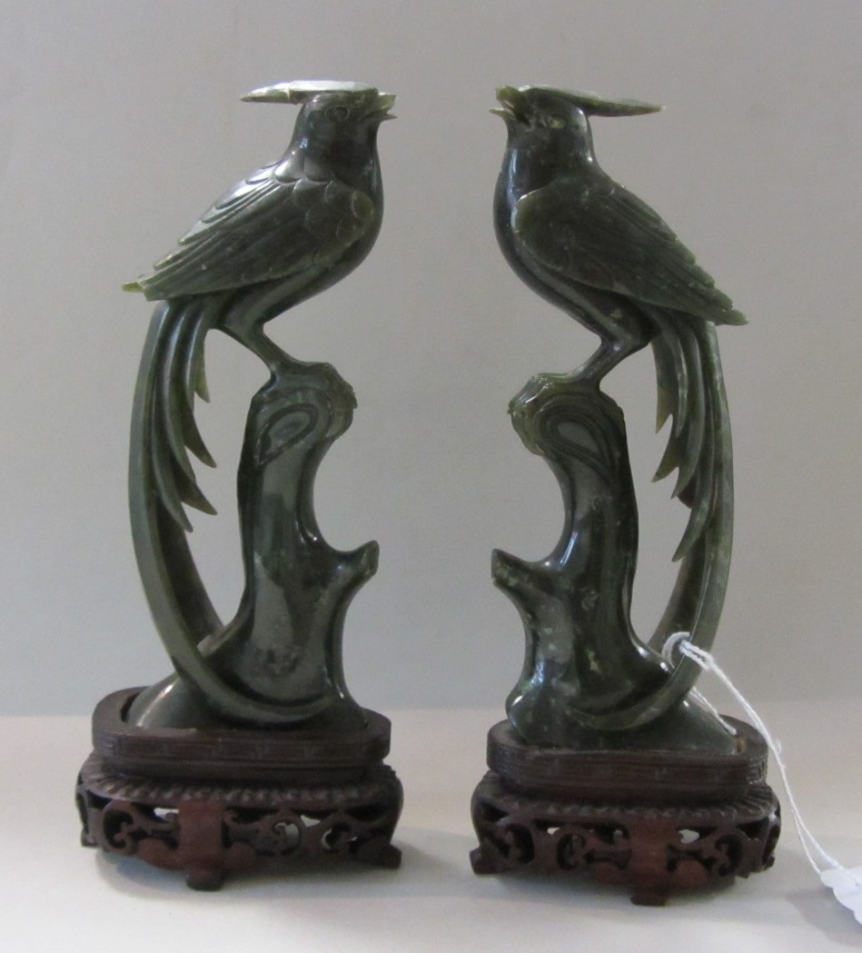 Appraisal: A pair of Chinese green hardstone models of birds th