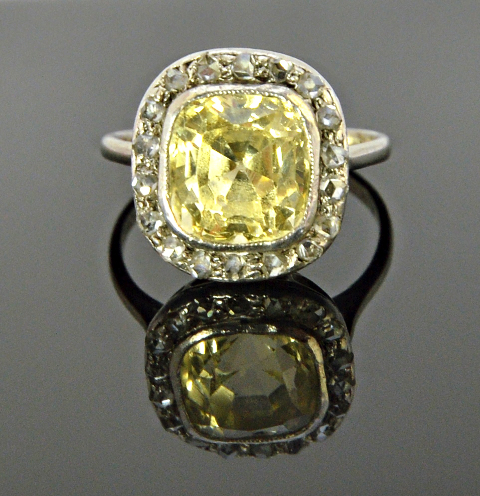 Appraisal: A yellow sapphire and diamond set cluster ring mounted with