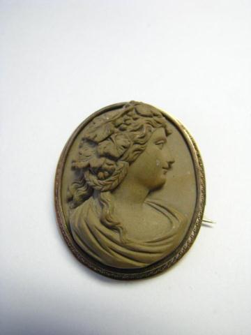 Appraisal: Oval antique hard stone cameo brooch and coordinating antique cupid