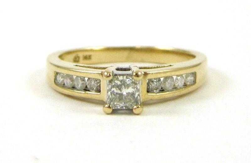 Appraisal: DIAMOND AND FOURTEEN KARAT GOLD RING with a row of