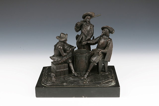 Appraisal: A CONTINENTAL BRONZE GROUP OF THREE CAVALIERS playing cards on