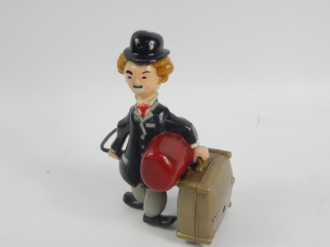 Appraisal: A clockwork figure of Charlie Chaplin carrying his suitcase and