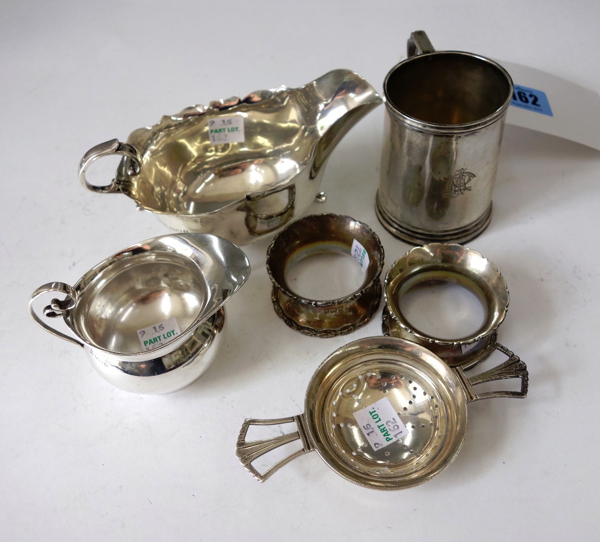 Appraisal: An Art Deco silver tea strainer and drip bowl Hukin