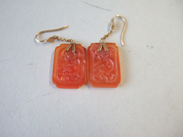 Appraisal: A pair of gold mounted carved cornelian pendant earrings the