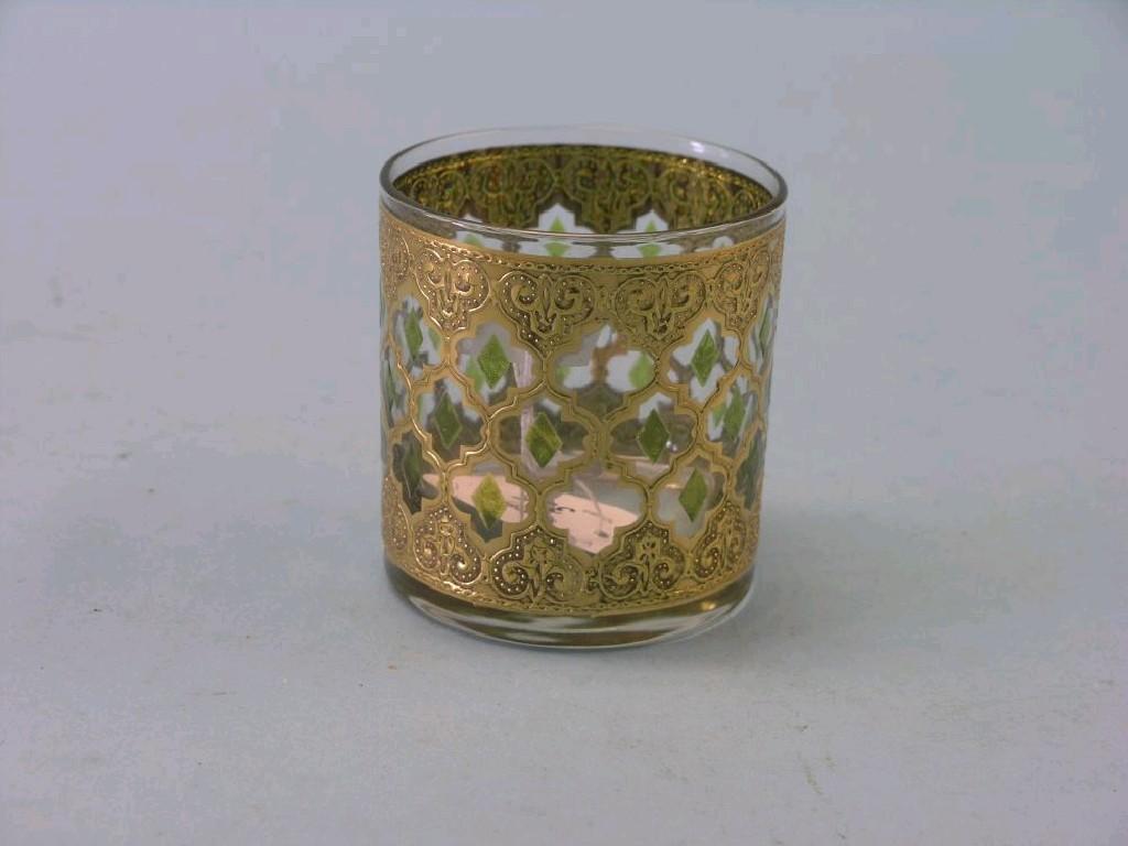 Appraisal: A Moser-type gilded glass tumbler burnished design inset with green-enamelled