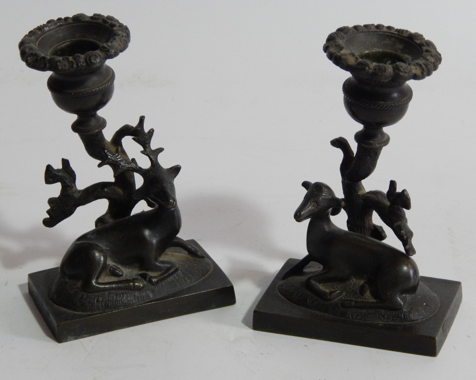 Appraisal: A pair of early thC bronze figural candlesticks with stag