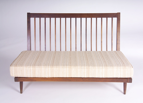 Appraisal: GEORGE NAKASHIMA Armless settee with slatted back and fabric-upholstered cushions