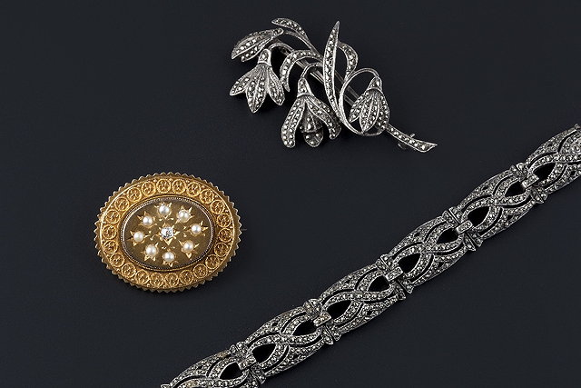 Appraisal: A half pearl and diamond set panel brooch the oval