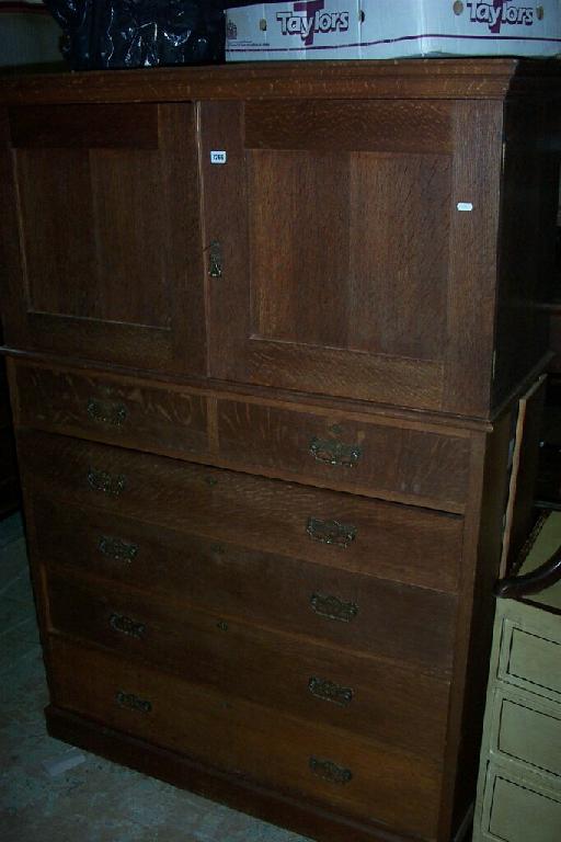 Appraisal: A plain oak chest cupboard the chest fitted with an