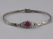 Appraisal: A white metal tests carat gold ruby and diamond bracelet