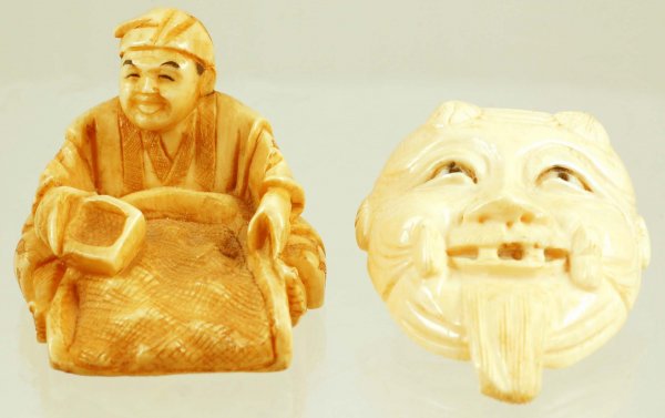 Appraisal: Two Japanese carved ivory figural netsukes One - x -