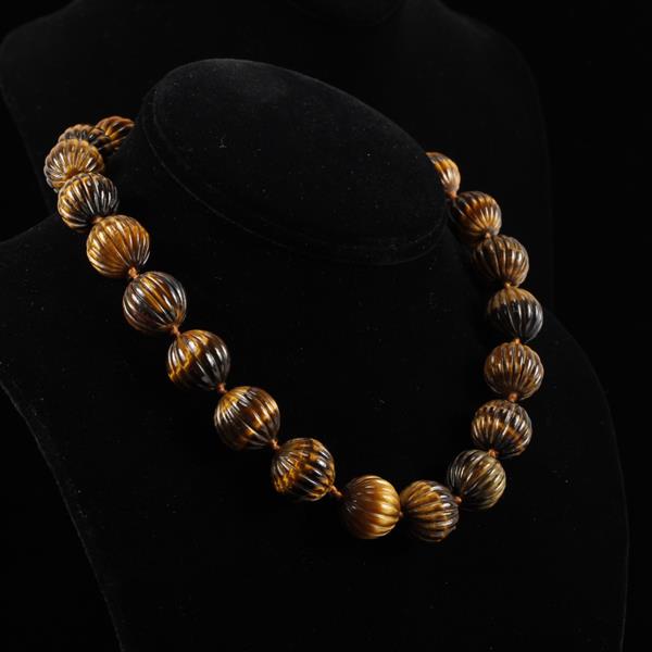 Appraisal: Carved and polished tiger eye stone knotted beaded necklace with