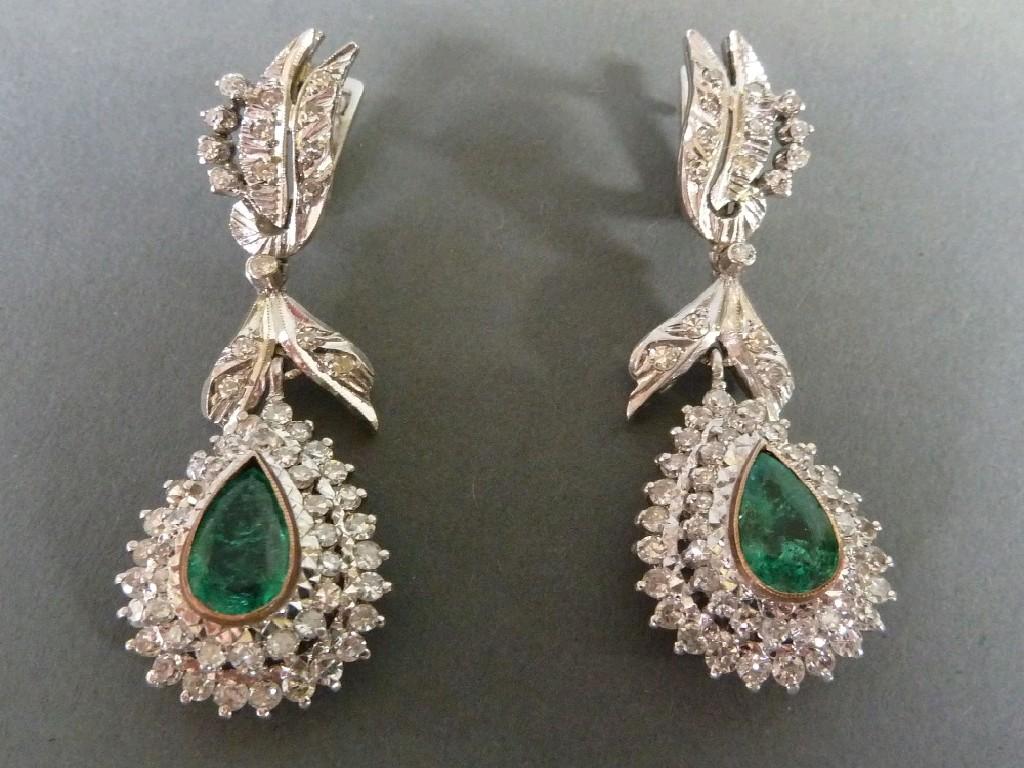 Appraisal: PAIR OF DIAMOND AND EMERALD DROP EARRINGS each with foliate