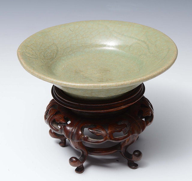 Appraisal: A CHINESE MING DYNASTY CELADON SHALLOW CIRCULAR BOWL with flared