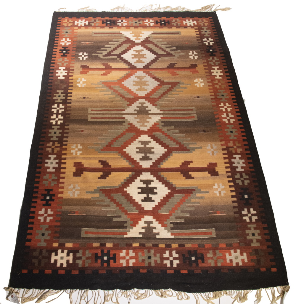 Appraisal: TH C NAVAJO RUG IN BROWN TONES Five Medallion Diamond