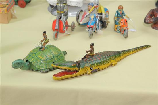 Appraisal: TWO TIN WIND-UP TOYS One of a figure riding and