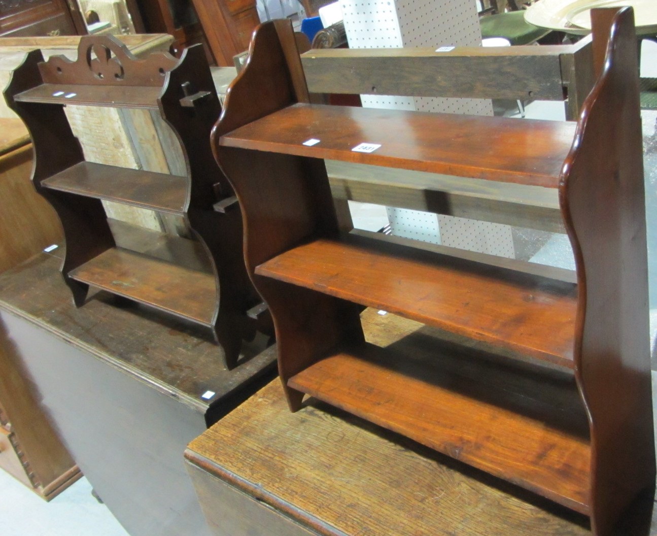 Appraisal: A mahogany three tier wall shelf with another similar