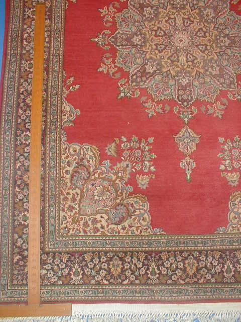 Appraisal: A Persian design rug with red ground centre field and