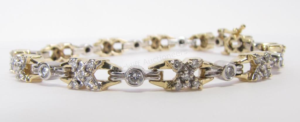 Appraisal: A K white and yellow gold diamond XO bracelet containing