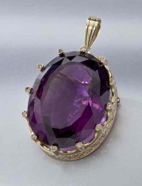 Appraisal: K gold amethyst and diamond pendantin a crown design frame