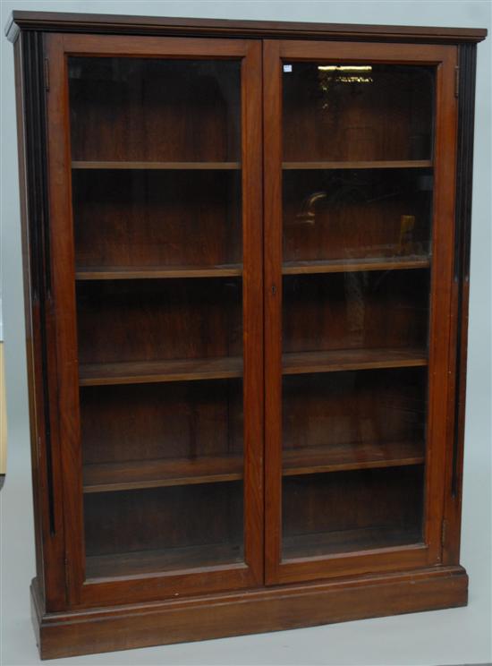 Appraisal: BOOKCASE A parcel ebonized walnut double door bookcase with fluted