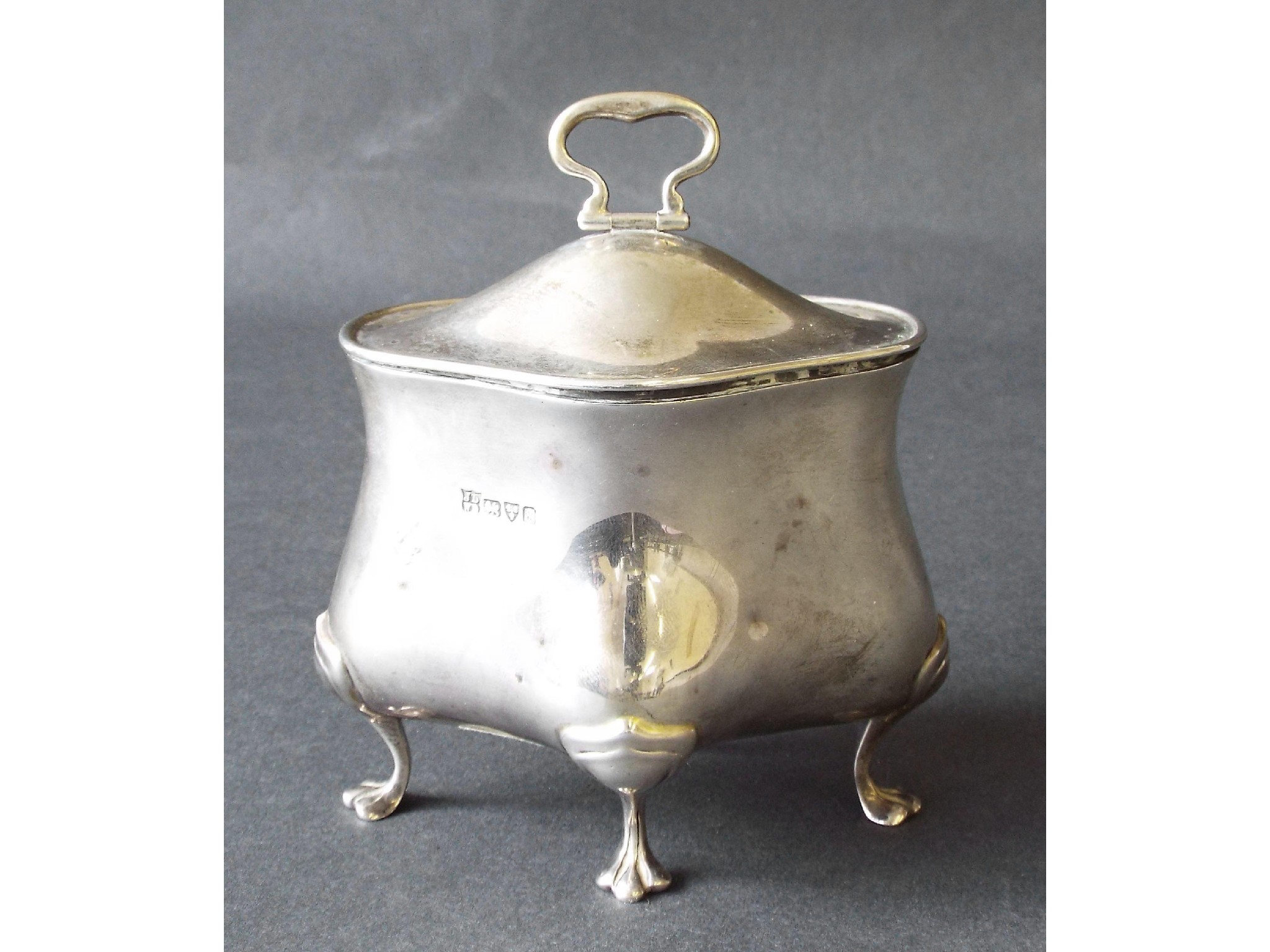 Appraisal: Edwardian bomb silver caddy with hinged lid and paw feet