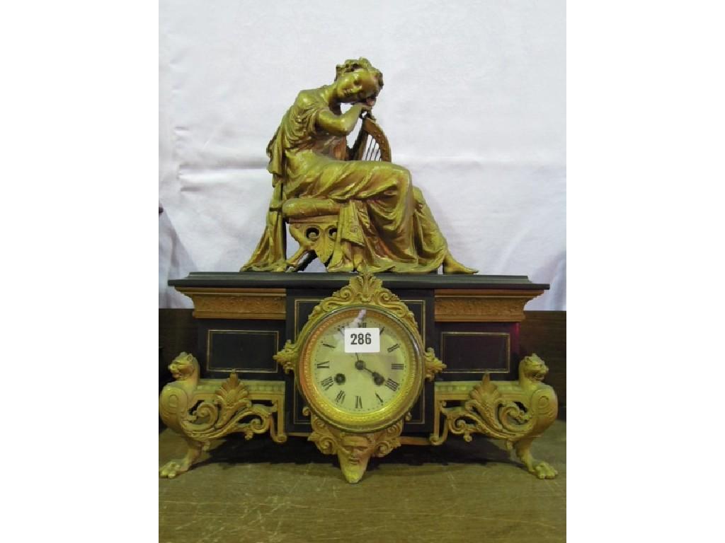 Appraisal: A Victorian black slate and spelter mantle clock adorned with