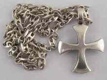 Appraisal: A white metal tests silver cross and chain the cross