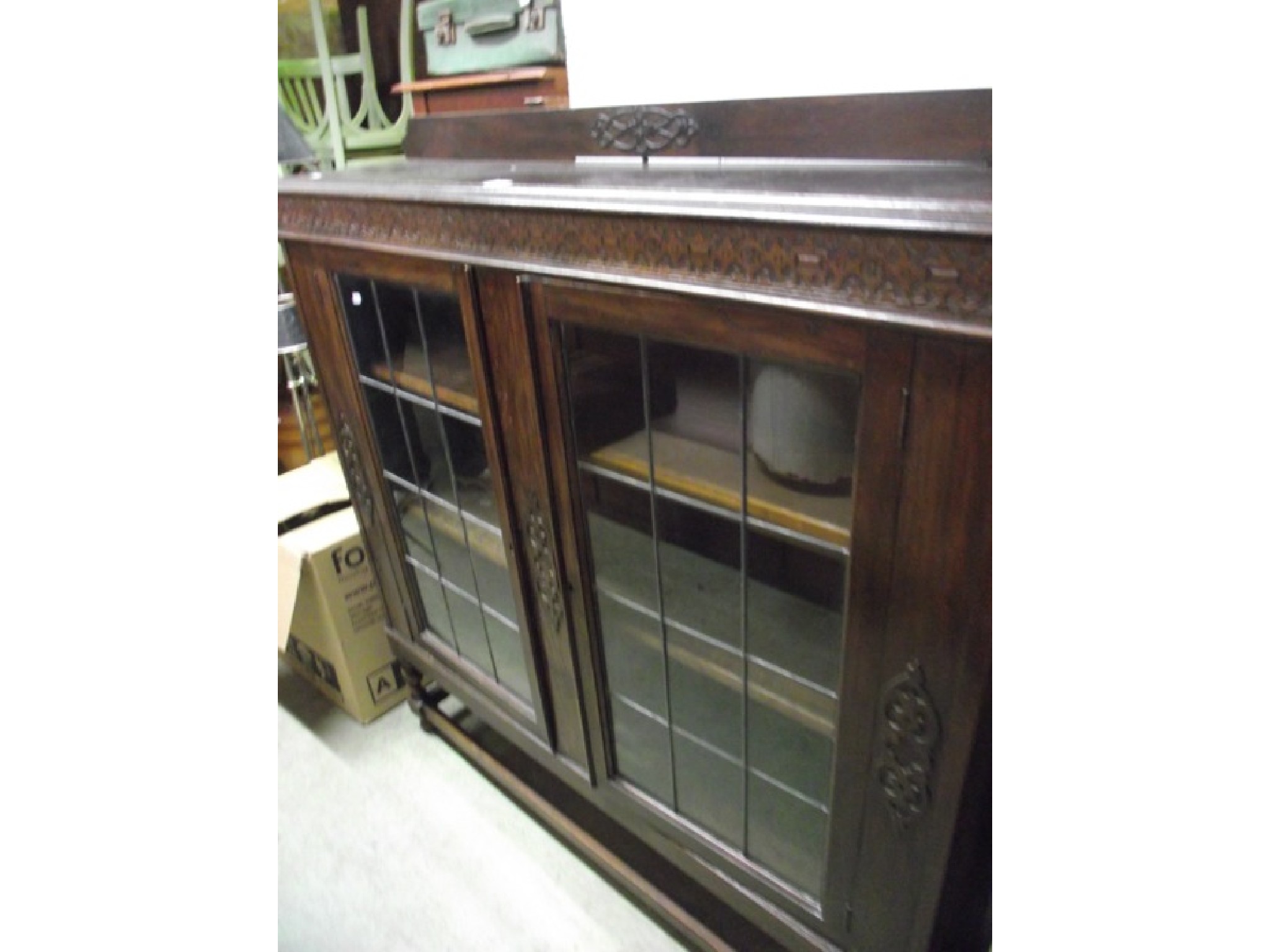 Appraisal: An early th century slender oak floorstanding side cabinet bookcase