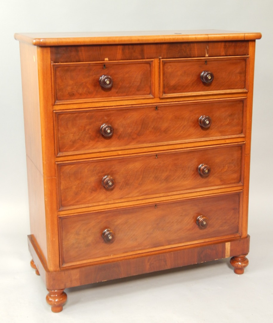 Appraisal: A Victorian flame figure mahogany chest of two short and