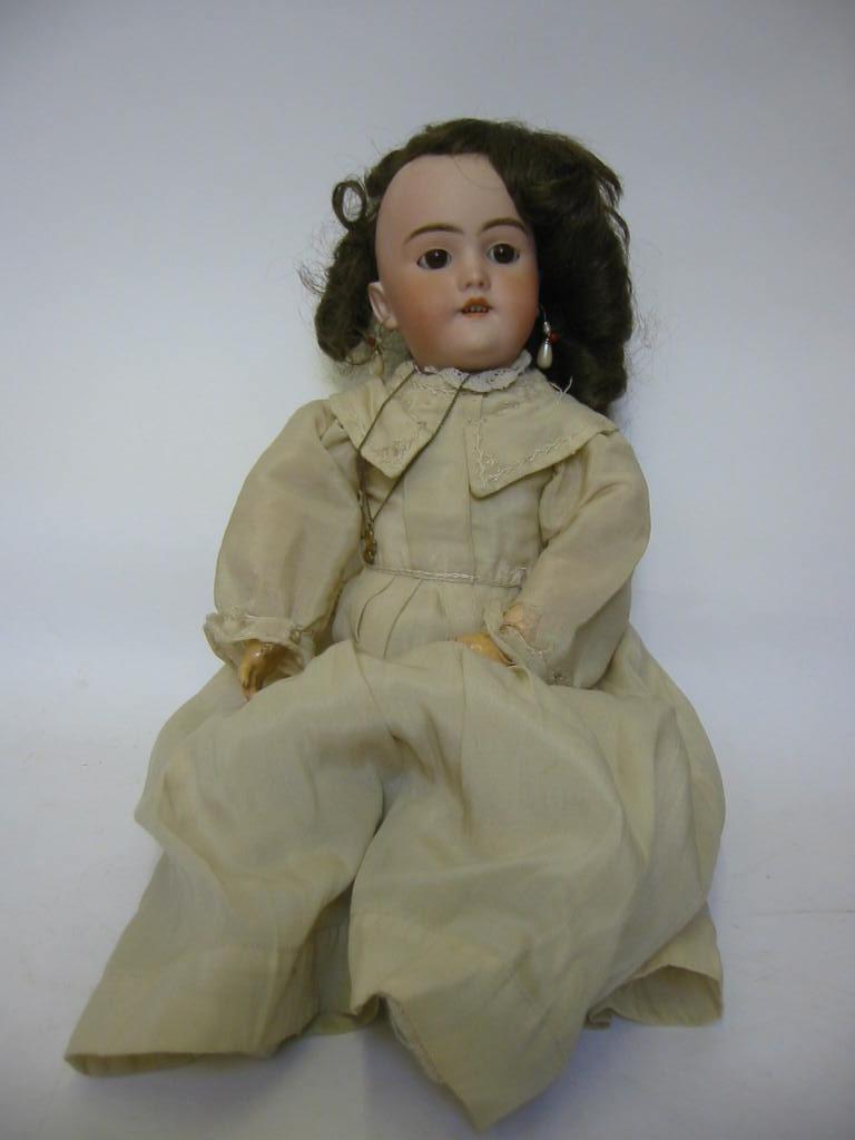 Appraisal: A Heinrich Handwerck bisque head girl doll with brown glass