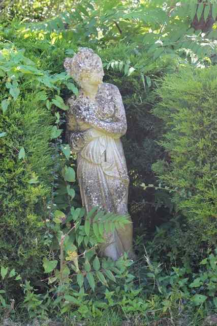 Appraisal: A RECONSTITUTED STONE FIGURE of a classical maiden high