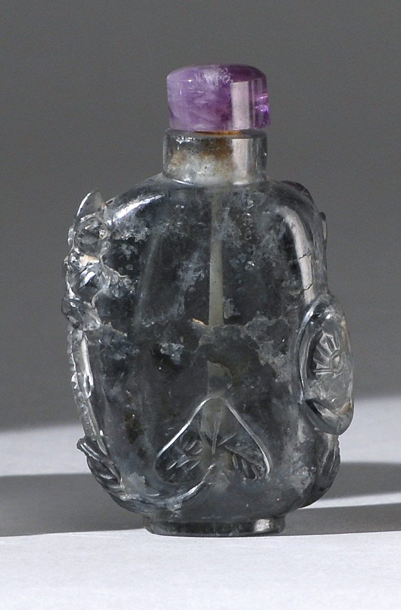 Appraisal: ROCK CRYSTAL SNUFF BOTTLE In flattened ovoid form with relief