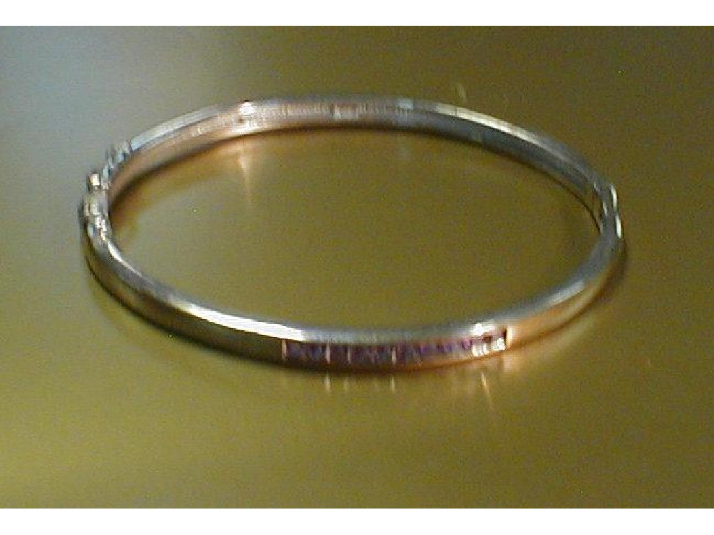 Appraisal: A narrow white metal hinged bangle with channel set lilac