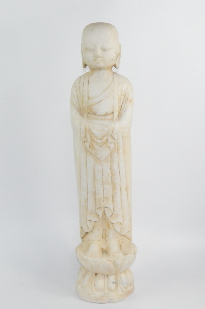 Appraisal: A reconstituted marble figure of Buddha modelled standing on a