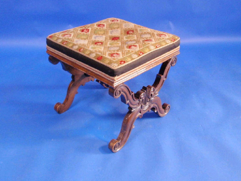 Appraisal: A Victorian carved walnut stool with woolwork top and carved