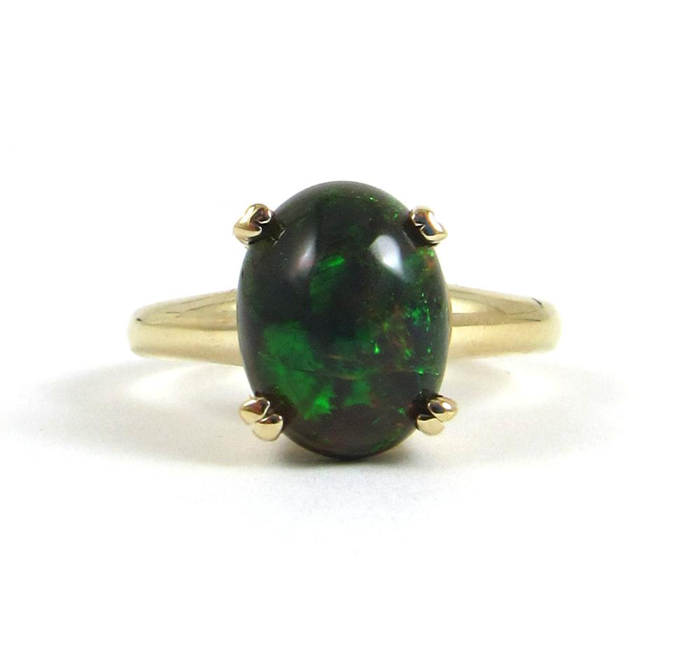 Appraisal: BLACK OPAL AND FOURTEEN KARAT GOLD SOLITAIRE RING with four