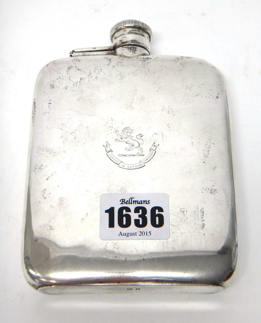 Appraisal: A silver curved rectangular spirit flask crest and motto engraved